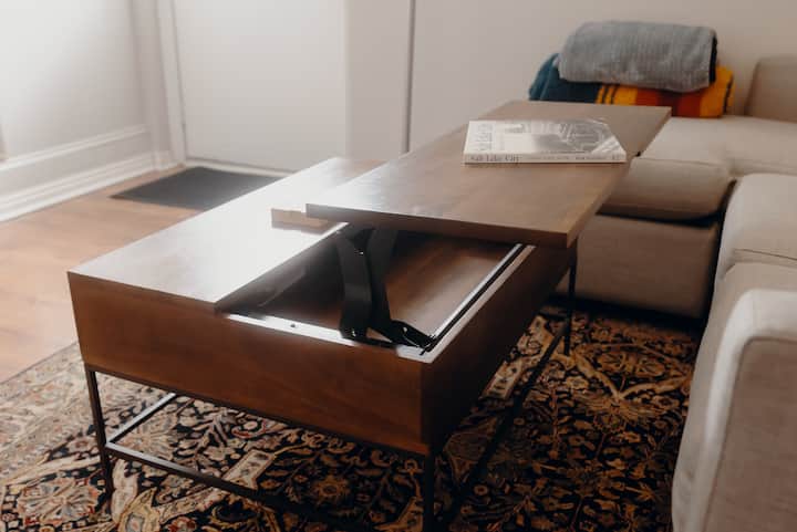 The living room’s lift-top coffee table, ready for a quiet workday