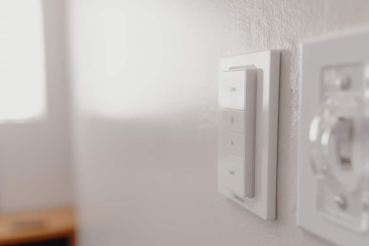 The apartment’s Hue smart switch beside the covered wall switch