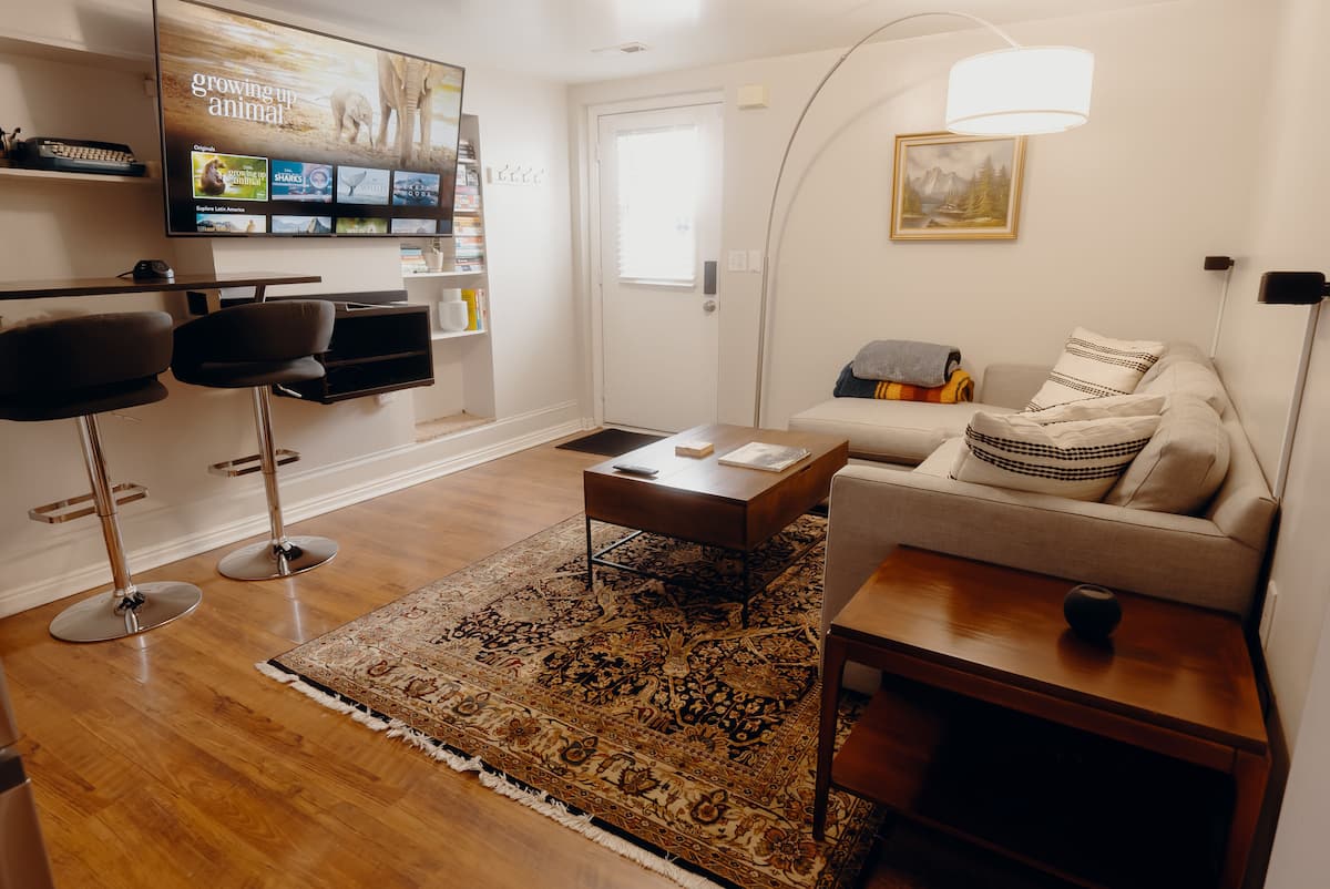 Your Cottonwood apartment living room, with a comfortable sofa, wool rug, and space to settle in